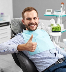 Patient at dentist thumbs up