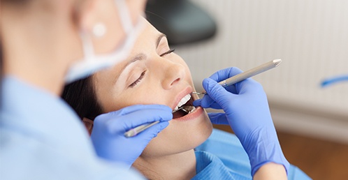 Woman receiving dental exam from sedation dentist in Jacksonville