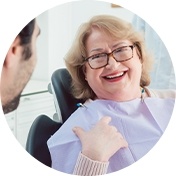 Woman with glasses sitting in dental chair