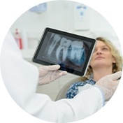 Dentist holding tablet with dental x ray