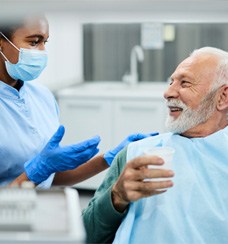 a patient smiling after receiving dentures in Jacksonville