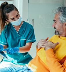 Dentist speaking and smiling at a patient in Jacksonville