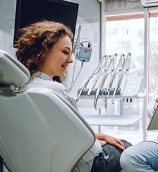 male dentist and female patient looking at iPad