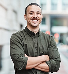 Smiling man standing on city street