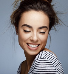 Woman smiling with eyes closed