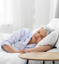 a mature woman sleeping in bed