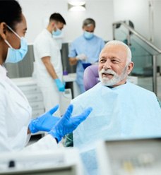 a dentist telling a patient about caring for his dentures