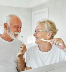 a dentist telling a patient about caring for his dentures