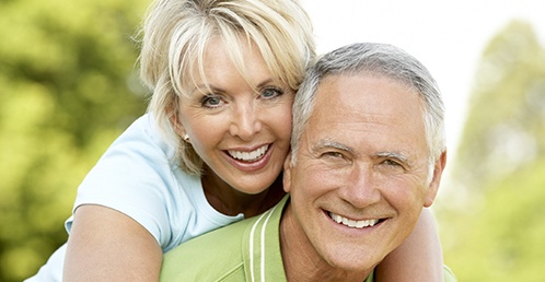 Smiling older couple with dentures in Jacksonville