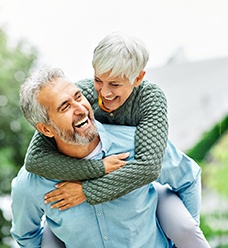 a mature couple smiling with dentures in Jacksonville