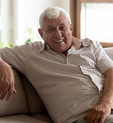 a smiling person sitting on a couch