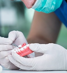 A technician working on a denture