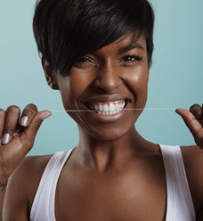 Woman flossing her teeth