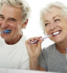 Couple brushing their teeth