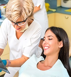 Younger woman learning about dental implants in Jacksonville