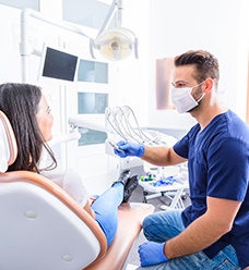 Dentist and patient talking in dental office