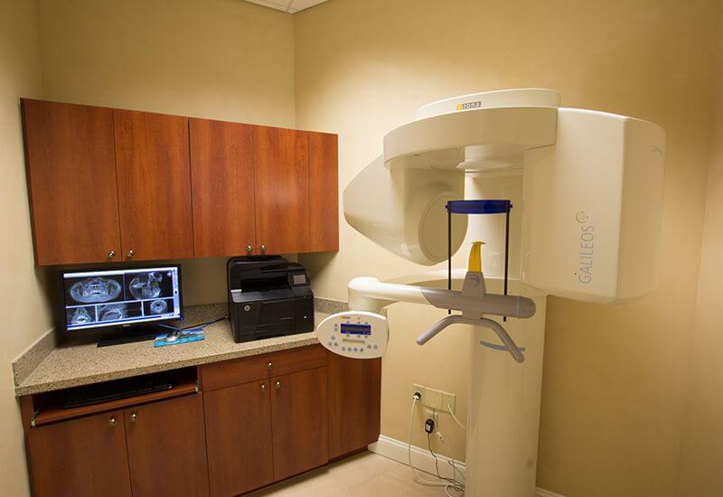 Dental scanning machine next to desk with computer