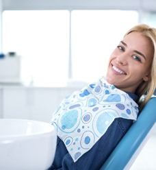 A woman smiling in the dentist chair