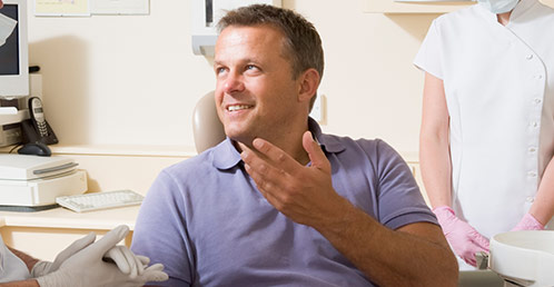 Man talking to dentist after dental services in Jacksonville