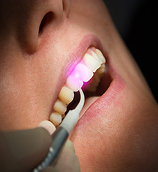 woman using soft tissue laser therapy