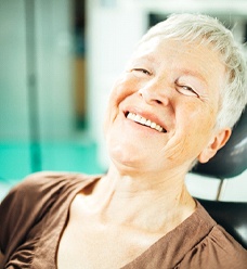 An older woman with dental implants in Jacksonville