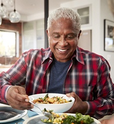 Man eating a meal with a family member