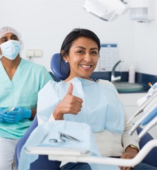 Woman giving thumbs up for sedation dentistry in Jacksonville