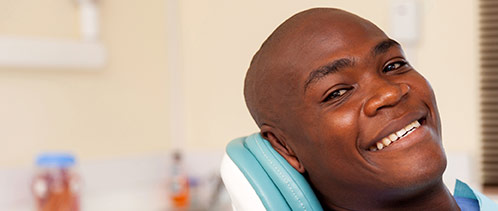 Smiling man leaning back in dental chair