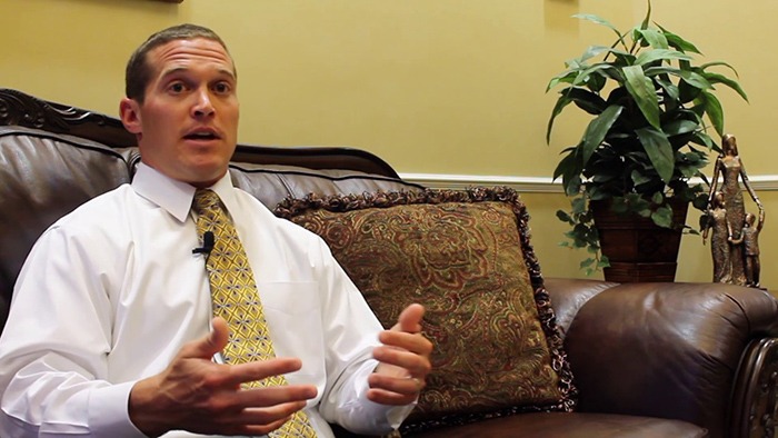 Doctor Nawrocki sitting on couch in dental office