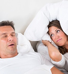 Man snoring with partner unhappy