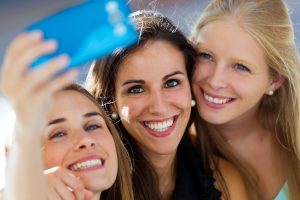 young friends smiling selfie 