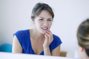 concerned woman touching jaw