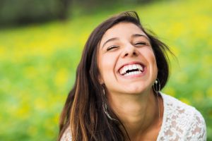 portrait of a woman smiling outdoors