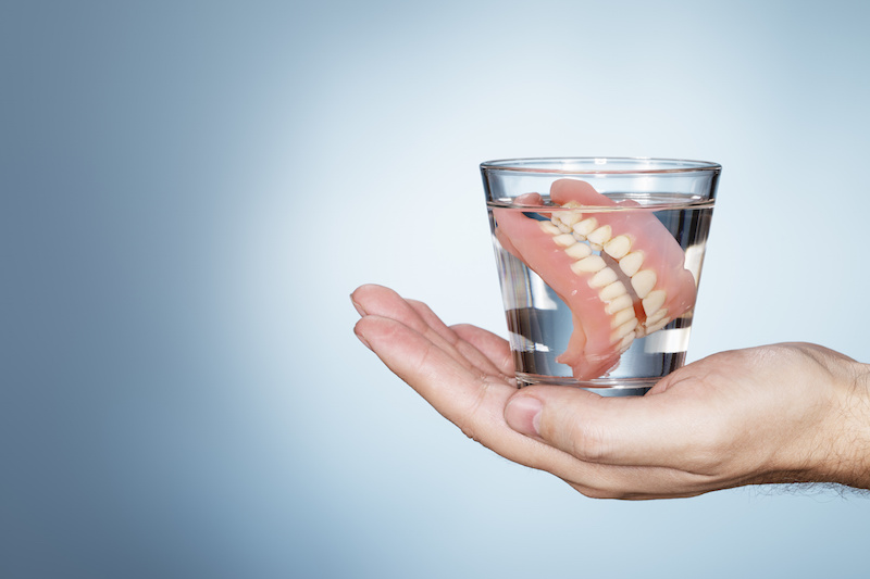 dentures in a glass of water