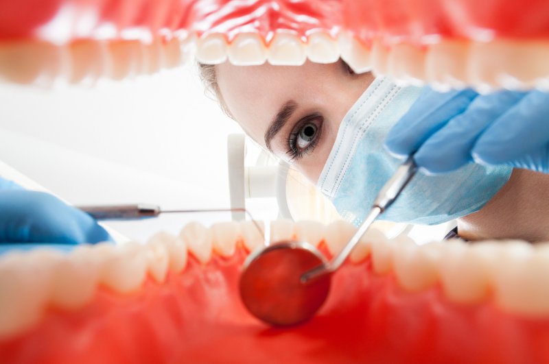 A dentist examining a mouth.