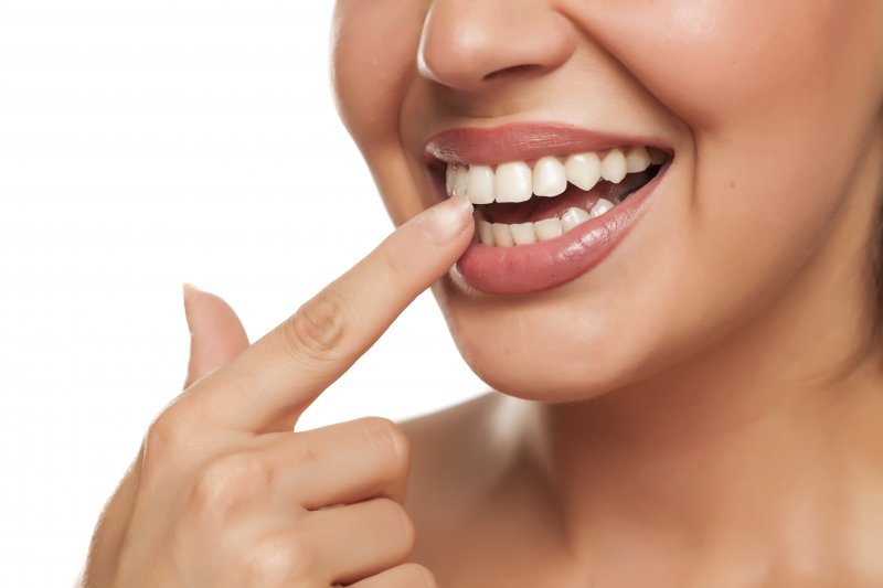 a woman touching her teeth