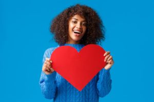 smiling woman holding heart