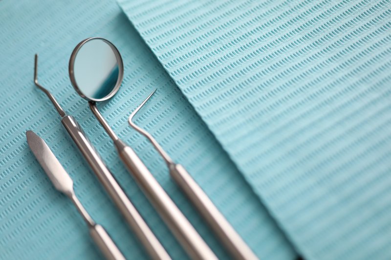 a row of dental instruments laid out in preparation for use 