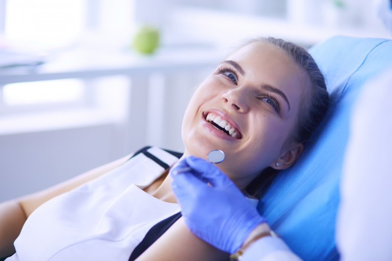 a young female patient smiling while visiting her dentist in Jacksonville