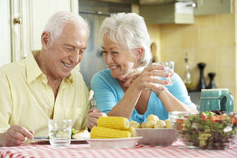 an older couple sitting at a table that is full of delicious summer foods in Jacksonville