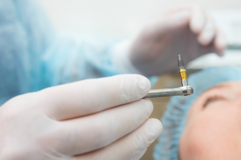 Dentist placing dental implant in Jacksonville