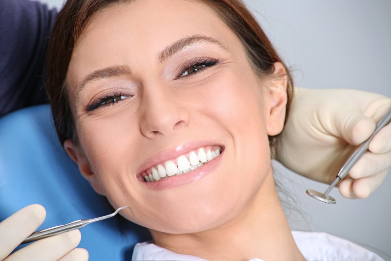 young woman smiling after seeing dentist in Jacksonville