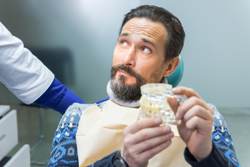 man listening to dentist during consultation