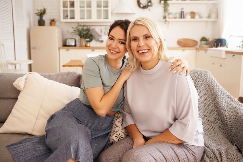 woman with dental implants and her daughter