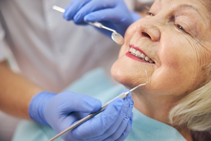 woman with dental implants at the dentist’s office