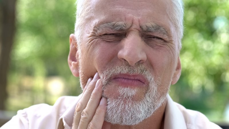 older man with dental implant sensitivity