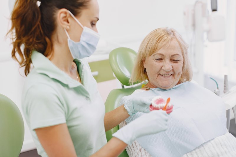 a woman learning to care for dental implants