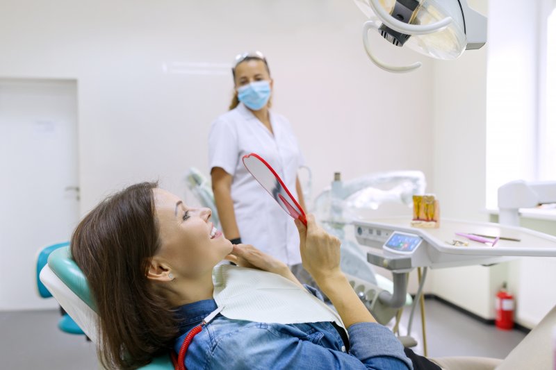 woman smiling after dental implant surgery