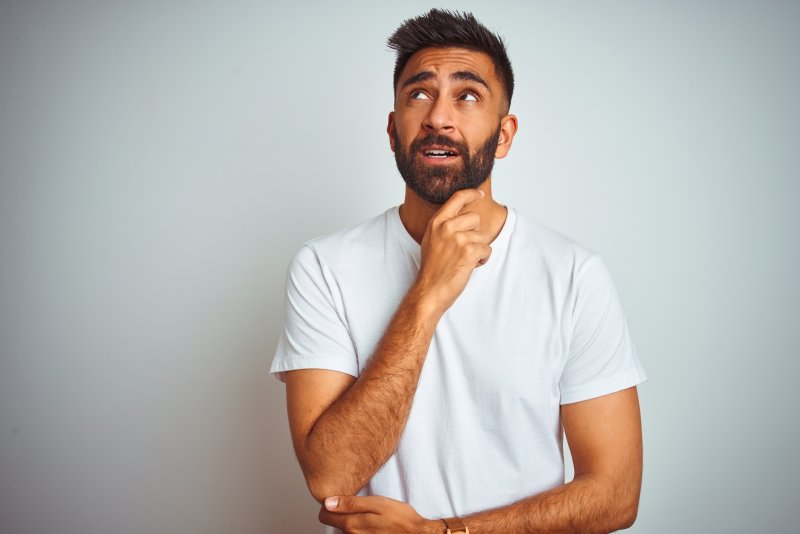 man thinking about a strange dental emergency in Jacksonville