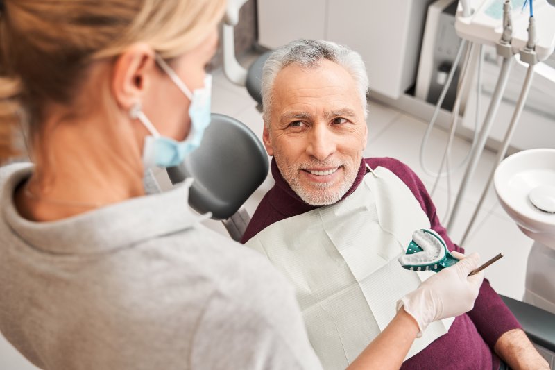 Dentist giving a patient a dental impression
